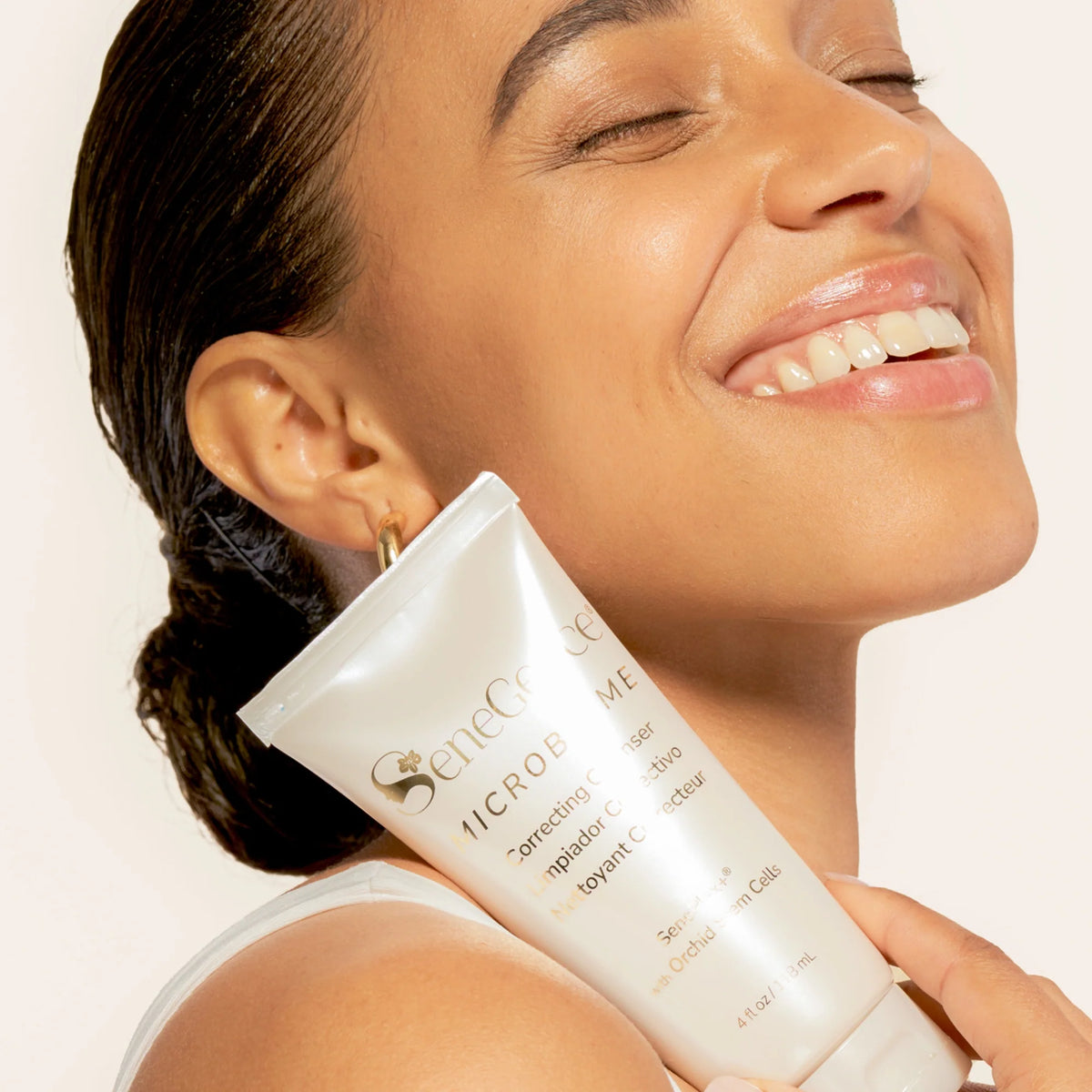 Model holding SeneGence Microbiome Correcting Cleanser product.