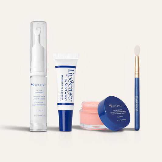 Ultimate Lip Care Collection NZL lineup with Lip Line Corrector in a tall clear pump, a white blue lip balm tube, a pink lip mask jar, and a blue handle applicator brush